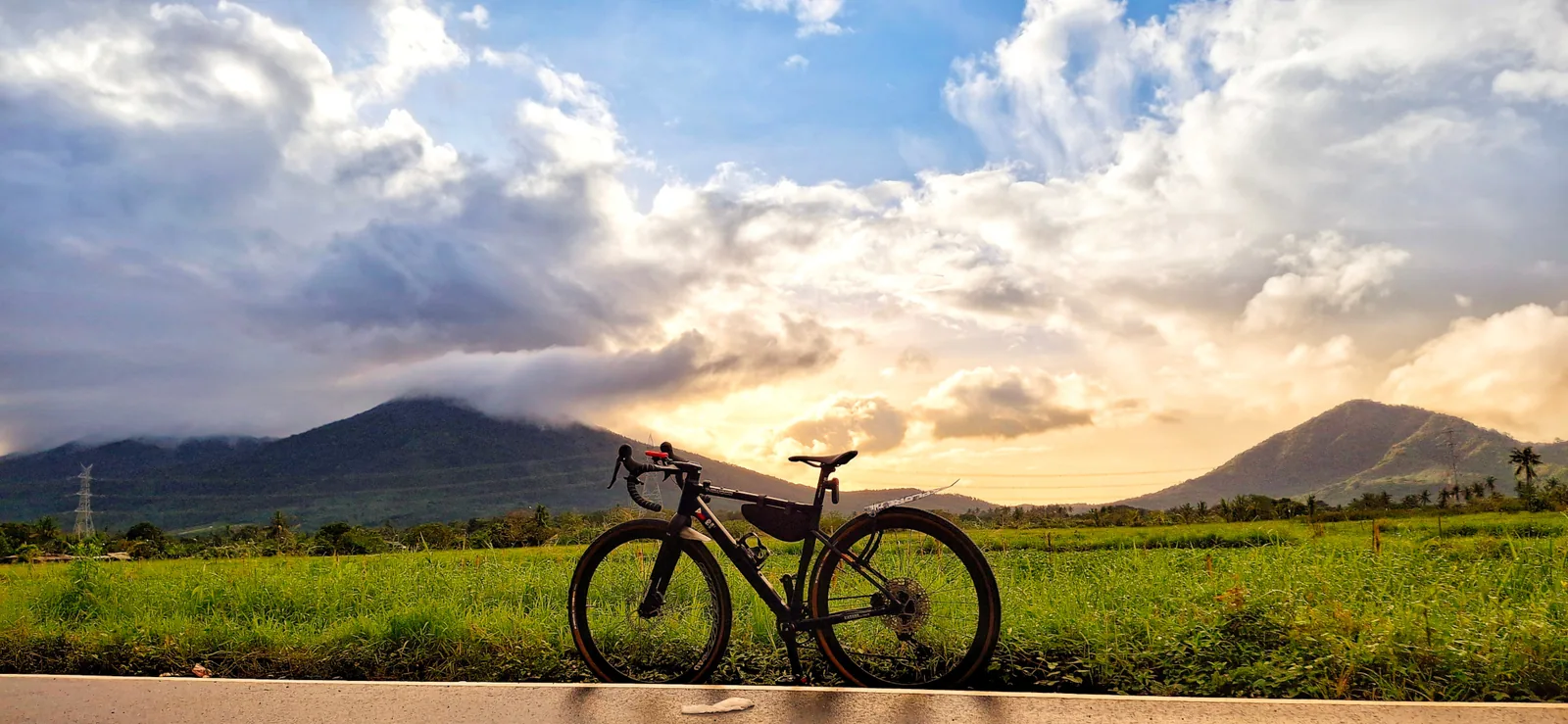 A bicycle against mountains in evening light