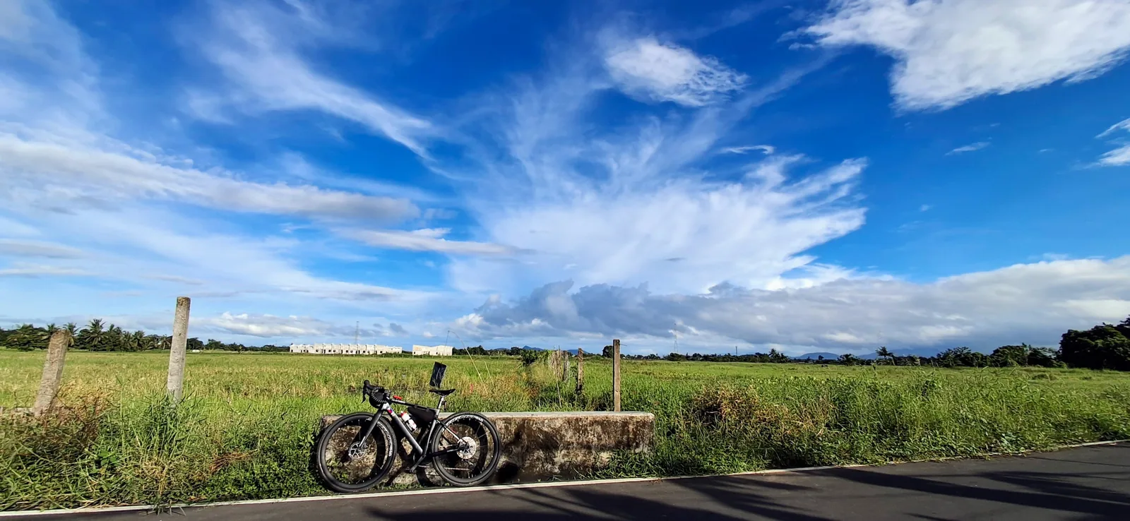 A bicycle beneath a broad blue sky